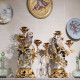 A pair of candelabras with porcelain owl and gilt-bronze vine