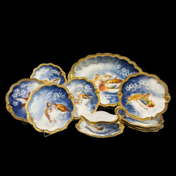 Porcelain service with wild birds on a blue background
